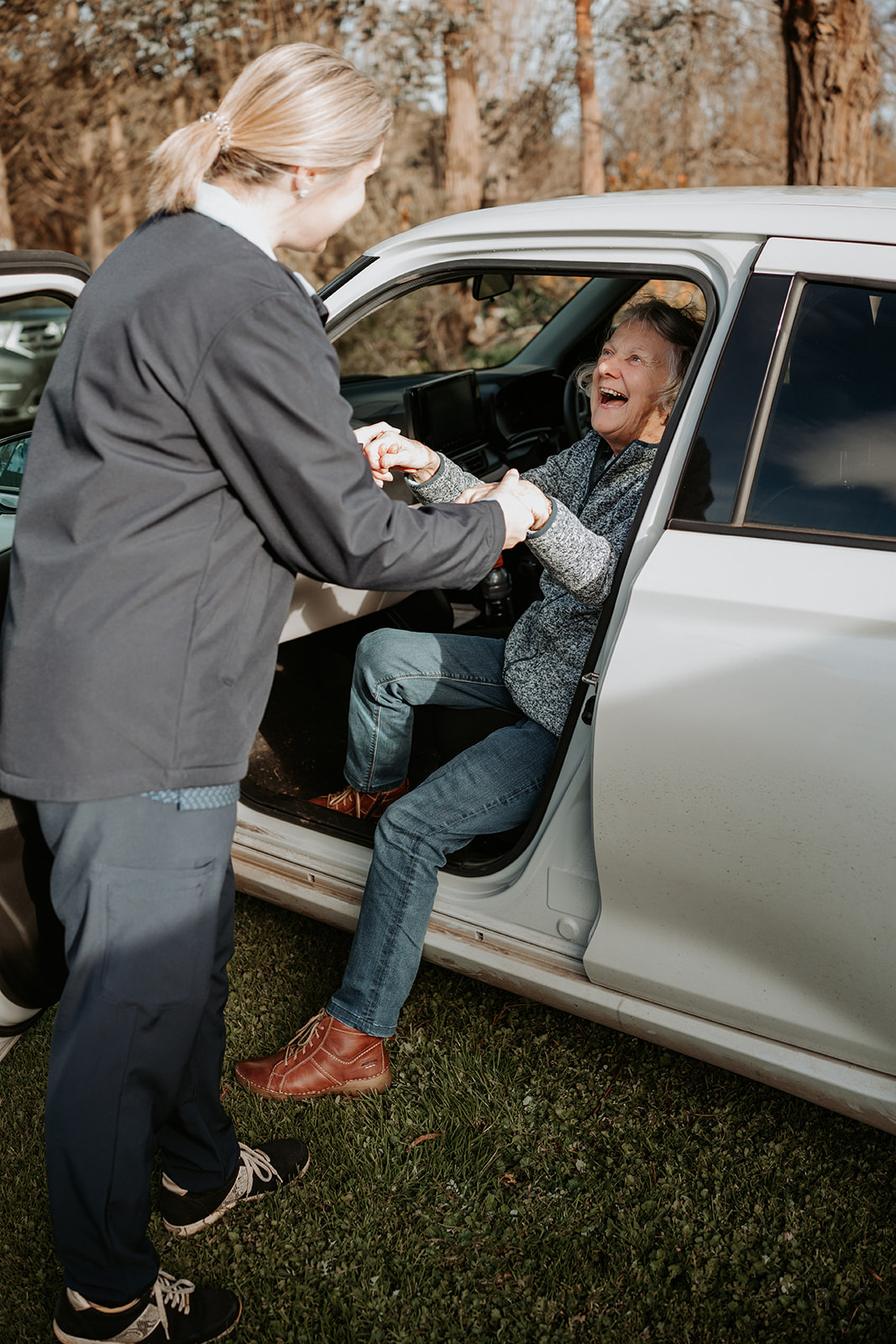Nurse assisting elderly woman safely out of a car during in-home care visit in Portland, Victoria.